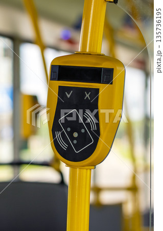 Closeup of bus contactless payment device with interior background and morning lighting environment 135736195
