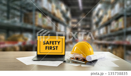 safety first Engineer desk in a warehouse Safety First shows a laptop with a hard hat, safety goggles, and blueprints, highlighting workplace PPE, risk management, and compliance training. safety first Engineer desk in a warehouse Safety First shows a laptop with a hard hat, safety goggles, and blueprints, highlighting workplace PPE, risk management, and compliance training. 135738835