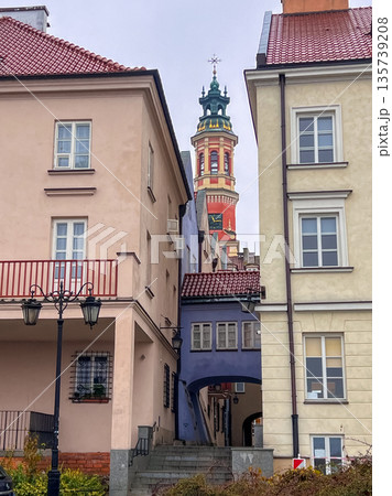 View of a narrow street with buildings and a tower in the background, Warsaw 135739208