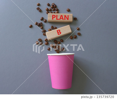 Plan B symbol. Wooden blocks with words Plan B. Beautiful grey background with coffee cup and coffee beans. Business and Plan B concept. Copy space. Plan B symbol. Wooden blocks with words Plan B. Beautiful grey background with coffee cup and coffee beans. Business and Plan B concept. Copy space. 135739720
