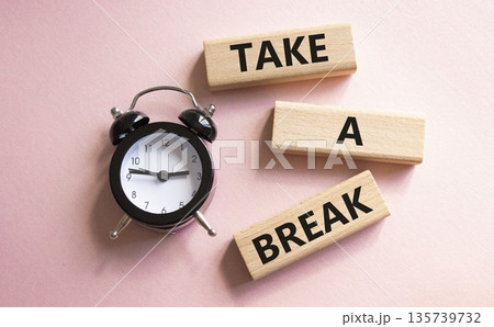 Take a break symbol. Concept words Take a break on wooden blocks. Beautiful pink background with alarm clock. Business and Take a break concept. Copy space. Take a break symbol. Concept words Take a break on wooden blocks. Beautiful pink background with alarm clock. Business and Take a break concept. Copy space. 135739732