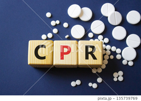 CPR symbol. Wooden cubes with words CPR Cardiopulmonary Resuscitation. Beautiful deep blue background. Healthcare and Cardiopulmonary Resuscitation concept. Copy space. CPR symbol. Wooden cubes with words CPR Cardiopulmonary Resuscitation. Beautiful deep blue background. Healthcare and Cardiopulmonary Resuscitation concept. Copy space. 135739769