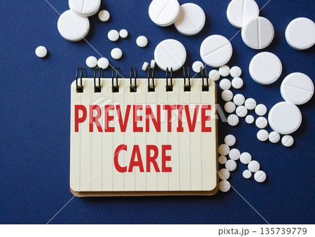 Preventive Care symbol. Concept word Preventive Care on notebook. Beautiful deep blue background with pills. Medicine and Preventive Care concept. Copy space 135739779