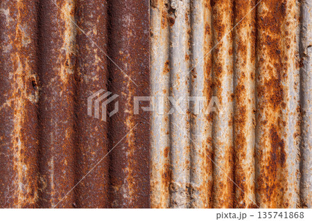 Weathered zinc sheet wall displays rustic texture with aged metal surface and visible corrosion creating vintage industrial appearance perfect for backgrounds 135741868