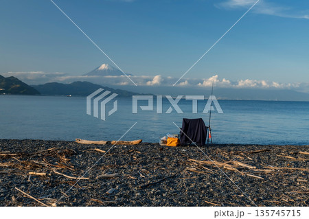 fishing rod and chair on black Miho beach with mt. Fuji, Shimizu 135745715