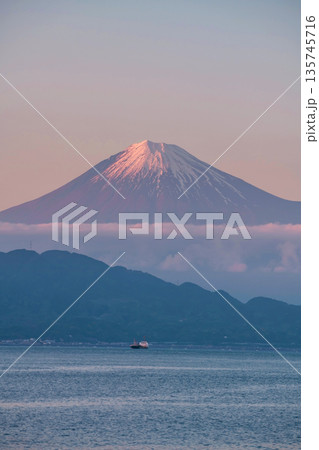 Mt. Fuji with twilight pink sky and sailing cargo container ship, Shimizu 135745716