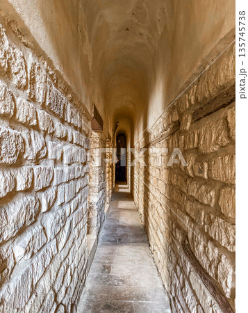 Qalawun complex interior at Al-Muizz Street in Cairo. Features Islamic architecture with arches, intricate designs, and a central courtyard with greenery. 135745738