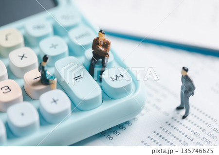 Miniature business people on pastel calculator and financial statement, symbolizing accounting teamwork, budgeting, tax planning, audit review and corporate finance decision making. Miniature business people on pastel calculator and financial statement, symbolizing accounting teamwork, budgeting, tax planning, audit review and corporate finance decision making. 135746625