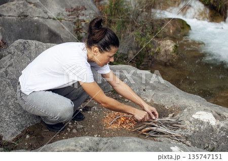 young pretty brunette girl hiking to waterfall, lifestyle people concept young pretty brunette girl hiking to waterfall, lifestyle people concept 135747151