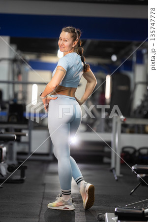 Fit woman posing, showing strong body in gym Fit woman posing, showing strong body in gym 135747778