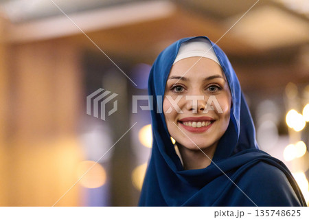 Smiling Woman in Blue Hijab Portrait for Fashion, Culture, and Modern Life Stock Photography Smiling Woman in Blue Hijab Portrait for Fashion, Culture, and Modern Life Stock Photography 135748625