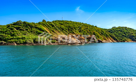 Panoramic view of the lush tropical coastline of Koh Samed island with turquoise waters and a clear blue sky 135748776