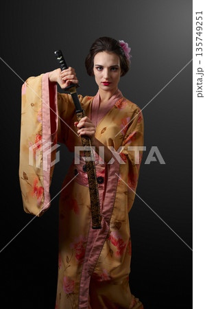 Beautiful woman in traditional japanese kimono with katana. Beautiful woman in traditional japanese kimono with katana. 135749251