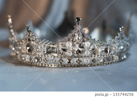 White crown with crystals, diamonds on grey background. White crown with crystals, diamonds on grey background. 135749256