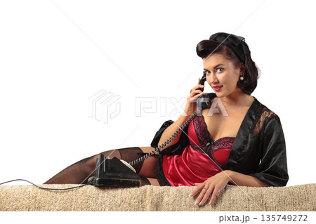 Beautiful woman speaking via vintage phone. 135749272