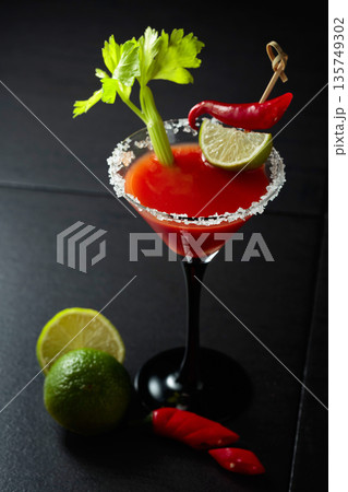 Bloody Mary cocktail with celery, lime, and red pepper. Bloody Mary cocktail with celery, lime, and red pepper. 135749302