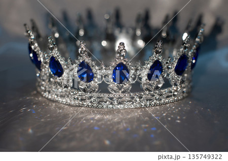Sapphire white golden crown on grey background. Blue gemstones. Sapphire white golden crown on grey background. Blue gemstones. 135749322