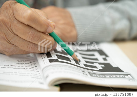 Bangkok, Thailand - May 15, 2022 elderly woman playing sudoku puzzle game. 135751097