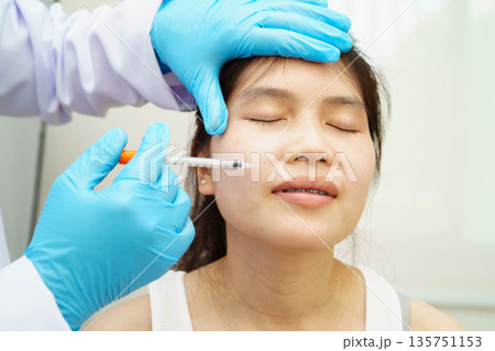 Asian woman receiving filler beauty injection. 135751153