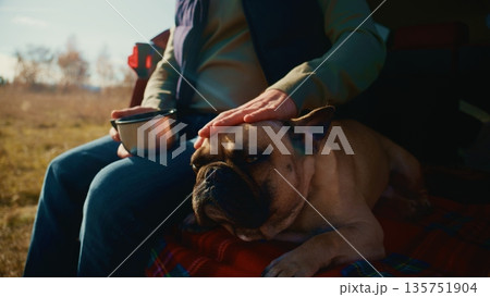 A Relaxing Moment in Nature: Enjoying Coffee While Petting a French Bulldog on a Sunny Day in the Outdoors A Relaxing Moment in Nature: Enjoying Coffee While Petting a French Bulldog on a Sunny Day in the Outdoors 135751904