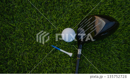 Golf grove and golf balls on a green lawn in a beautiful golf course with morning sunshine. 135752728