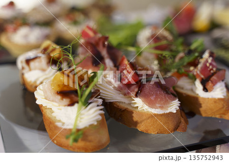 Delicious gourmet appetizers arranged beautifully on a serving platter Delicious gourmet appetizers arranged beautifully on a serving platter 135752943