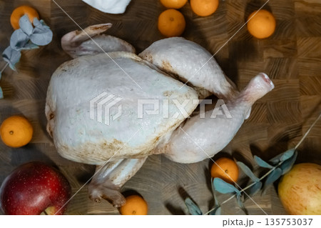 Whole raw turkey or chicken ready for cooking. Uncooked poultry meat for Thanksgiving or Christmas dinner preparation, top view. Whole raw turkey or chicken ready for cooking. Uncooked poultry meat for Thanksgiving or Christmas dinner preparation, top view. 135753037