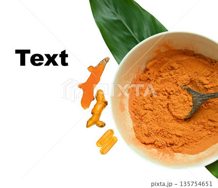 Top view of turmeric powder in a bowl, fresh turmeric root, turmeric capsules, and sliced turmeric arranged with space for text. 135754651