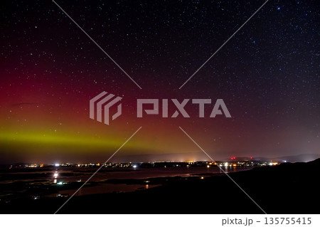 The Aurora Borealis, the northern lights, showing up above Maghery, Burtonport, Arranmore and Dungloe in County Donegal, Ireland. 135755415