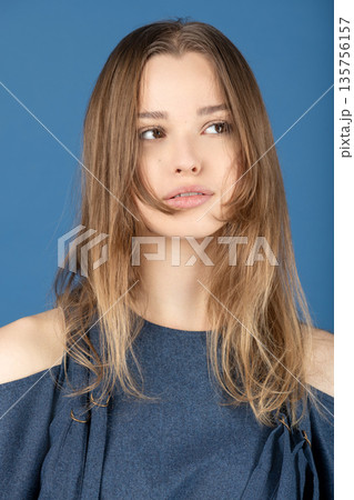 Beautiful young woman looking away with confidence 135756157