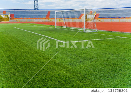 STADIUM - Football field with goal and tablo on blue sky 135756801