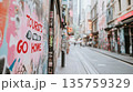 Curvy narrow street with residential buildings and protest graffiti Tourists Go Home, overtourism concept 135759329