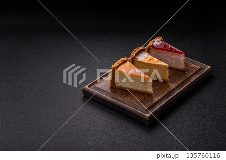 Cheesecake, a slice of sweet pie, a classic cheese dessert. Cheesecake as a food background Cheesecake, a slice of sweet pie, a classic cheese dessert. Cheesecake as a food background 135760116
