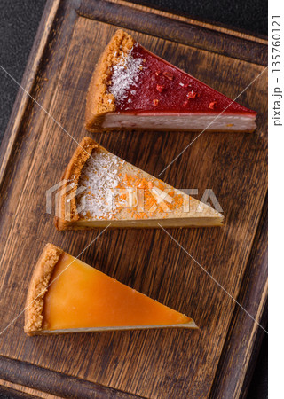 Cheesecake, a slice of sweet pie, a classic cheese dessert. Cheesecake as a food background Cheesecake, a slice of sweet pie, a classic cheese dessert. Cheesecake as a food background 135760121