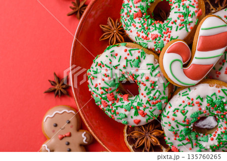 Christmas donuts or doughnuts, holiday winter sweets with sprinkles. Christmas donuts Christmas donuts or doughnuts, holiday winter sweets with sprinkles. Christmas donuts 135760265
