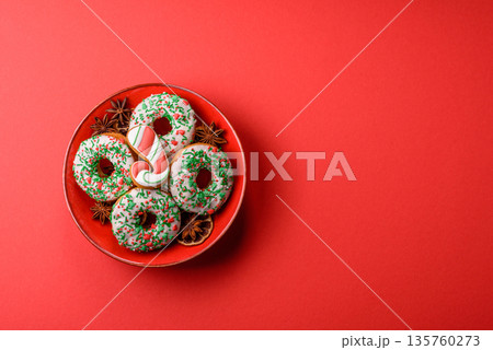 Christmas donuts or doughnuts, holiday winter sweets with sprinkles. Christmas donuts Christmas donuts or doughnuts, holiday winter sweets with sprinkles. Christmas donuts 135760273
