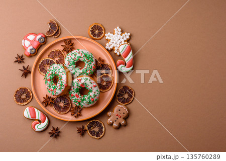 Christmas donuts or doughnuts, holiday winter sweets with sprinkles. Christmas donuts 135760289