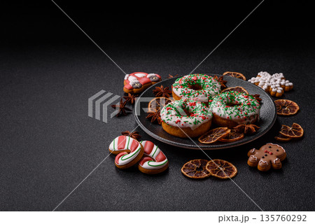 Christmas donuts or doughnuts, holiday winter sweets with sprinkles. Christmas donuts Christmas donuts or doughnuts, holiday winter sweets with sprinkles. Christmas donuts 135760292