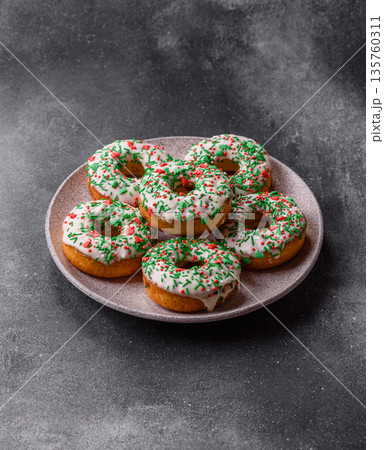 Christmas donuts or doughnuts, holiday winter sweets with sprinkles. Christmas donuts 135760311