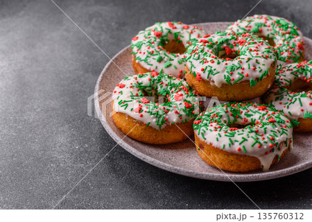 Christmas donuts or doughnuts, holiday winter sweets with sprinkles. Christmas donuts Christmas donuts or doughnuts, holiday winter sweets with sprinkles. Christmas donuts 135760312