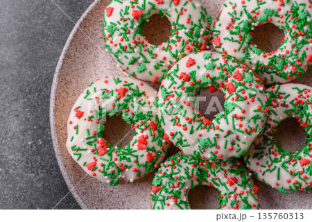 Christmas donuts or doughnuts, holiday winter sweets with sprinkles. Christmas donuts 135760313