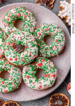 Christmas donuts or doughnuts, holiday winter sweets with sprinkles. Christmas donuts Christmas donuts or doughnuts, holiday winter sweets with sprinkles. Christmas donuts 135760318