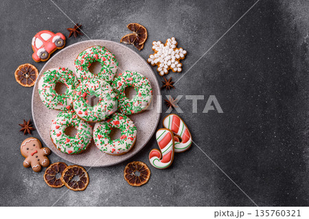 Christmas donuts or doughnuts, holiday winter sweets with sprinkles. Christmas donuts Christmas donuts or doughnuts, holiday winter sweets with sprinkles. Christmas donuts 135760321
