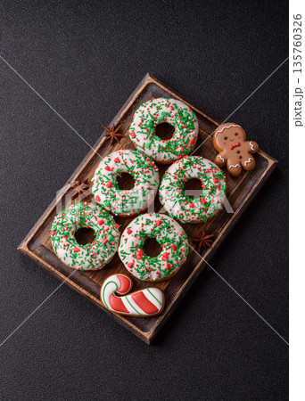 Christmas donuts or doughnuts, holiday winter sweets with sprinkles. Christmas donuts Christmas donuts or doughnuts, holiday winter sweets with sprinkles. Christmas donuts 135760326