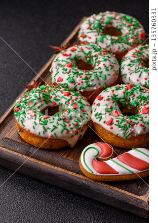 Christmas donuts or doughnuts, holiday winter sweets with sprinkles. Christmas donuts Christmas donuts or doughnuts, holiday winter sweets with sprinkles. Christmas donuts 135760331