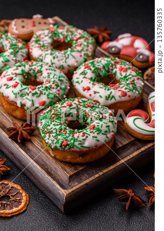 Christmas donuts or doughnuts, holiday winter sweets with sprinkles. Christmas donuts Christmas donuts or doughnuts, holiday winter sweets with sprinkles. Christmas donuts 135760335