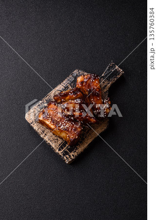 Grilled or bbq pork ribs with sauce, a food prepared for dinner. Grilled ribs 135760384