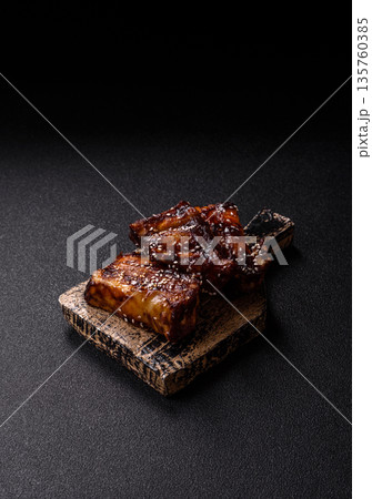 Grilled or bbq pork ribs with sauce, a food prepared for dinner. Grilled ribs 135760385