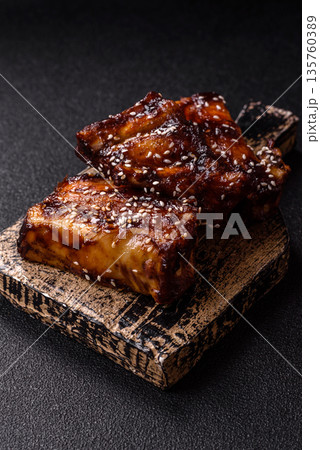 Grilled or bbq pork ribs with sauce, a food prepared for dinner. Grilled ribs 135760389