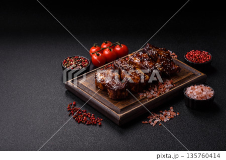 Grilled or bbq pork ribs with sauce, a food prepared for dinner. Grilled ribs Grilled or bbq pork ribs with sauce, a food prepared for dinner. Grilled ribs 135760414